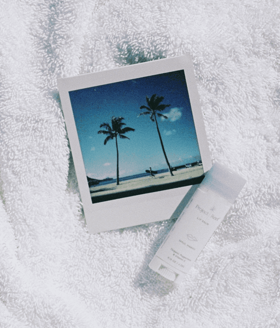 Picture of a polaroid image and Project Reef sunscreen on a towel