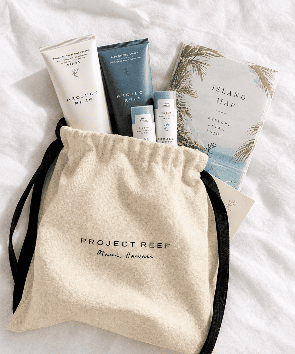 A beautifully assembled destination wedding welcome bag with sunscreen and a local map by Project Reef.