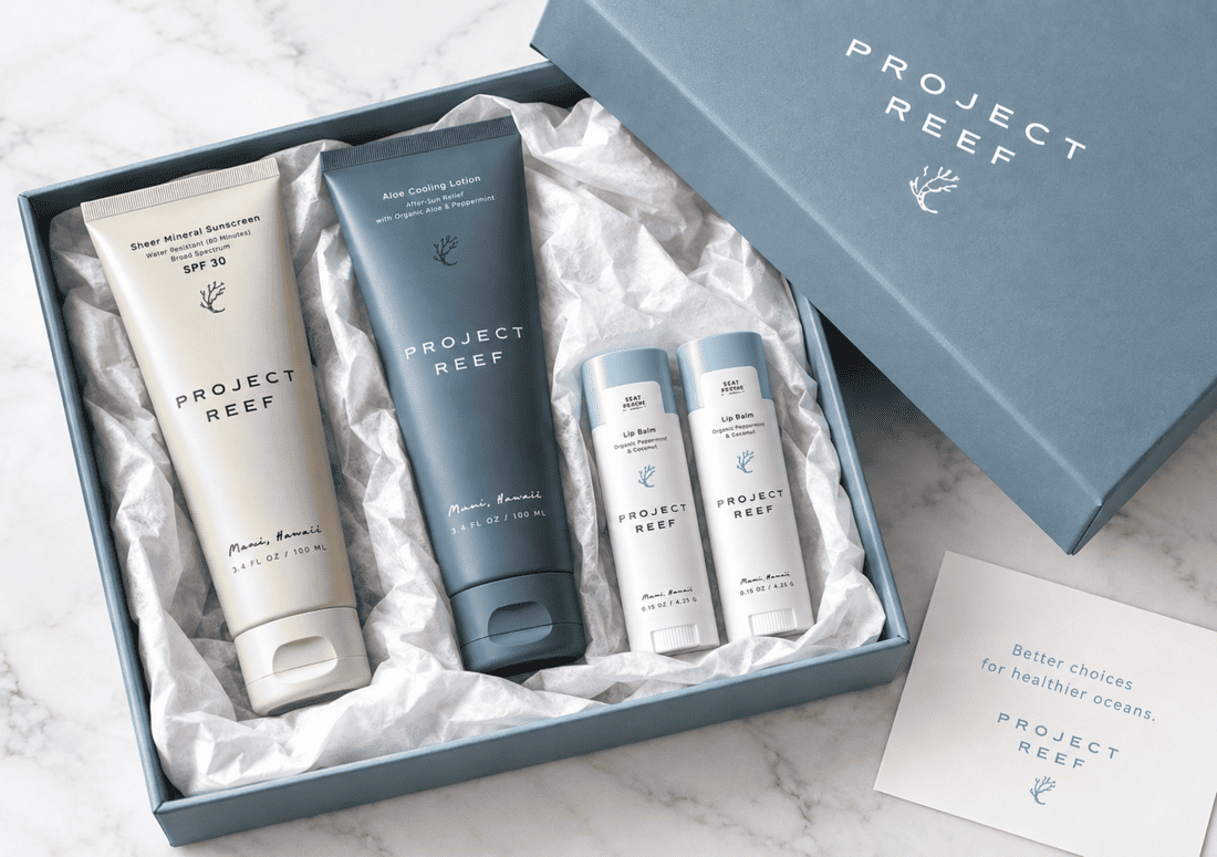 A beautifully packaged corporate gift set on white marble surface, showing Project Reef sunscreen products.