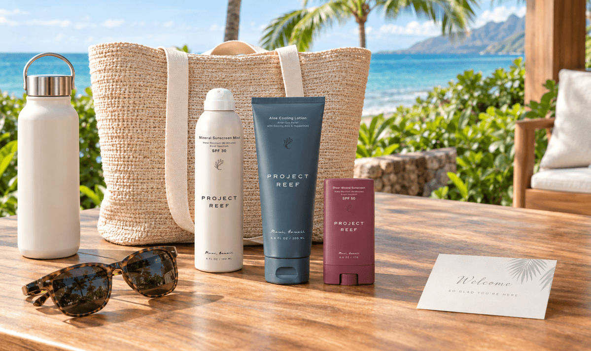 A premium corporate swag gift set on a sunlit Hawaiian resort table, featuring Project Reef mineral sunscreen.