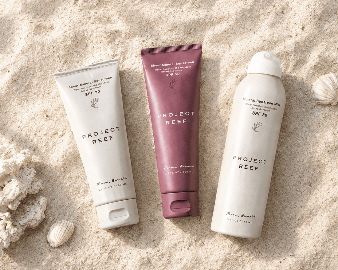 Project Reef non toxic mineral sunscreen products on a light sand background.