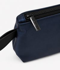 Navy blue sun care pouch with a zipper on a white background