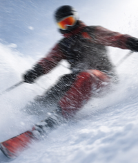 Person skiing in a snowy landscape, where sunscreen protection is essential against UV exposure