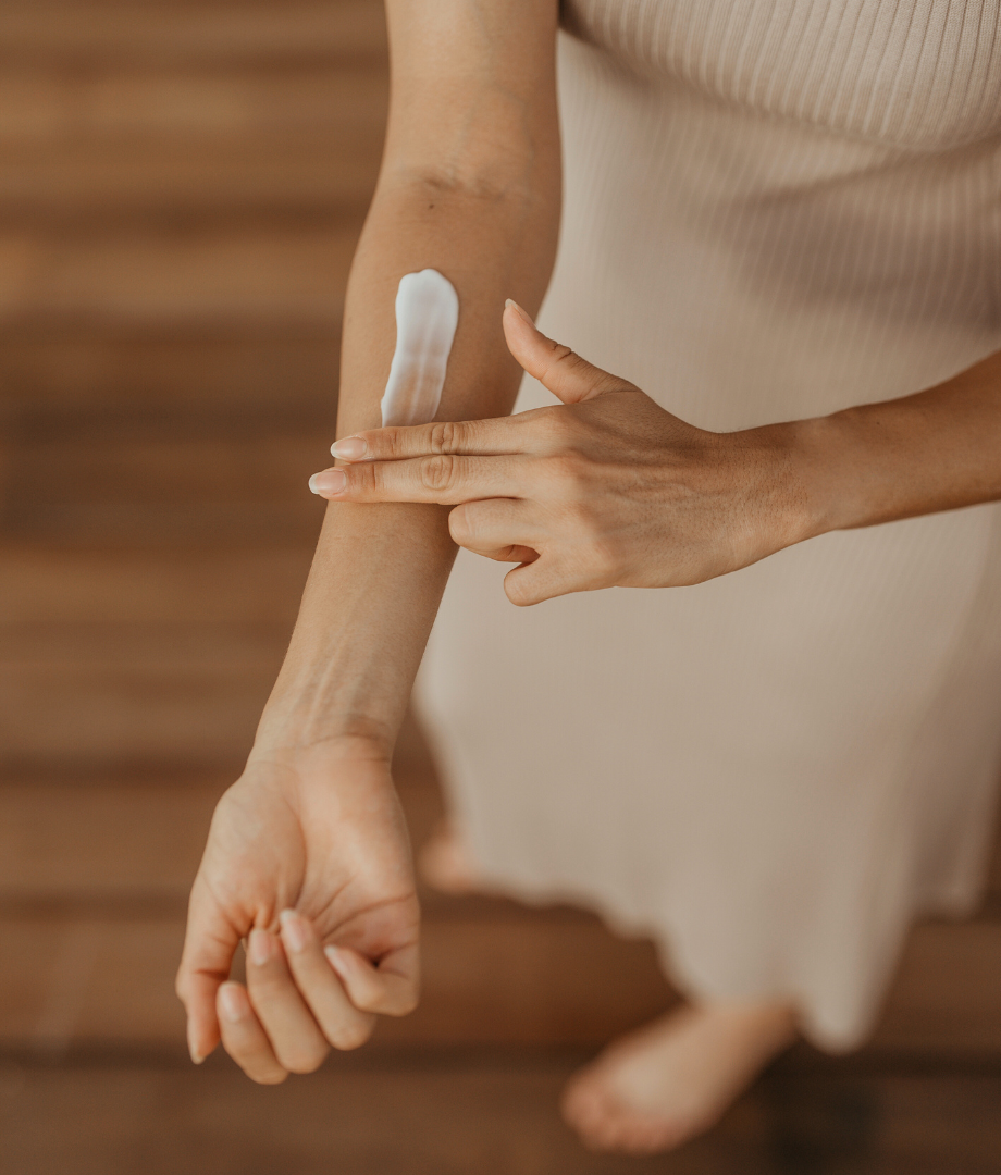 Girl applying mineral based sunscreen on arm