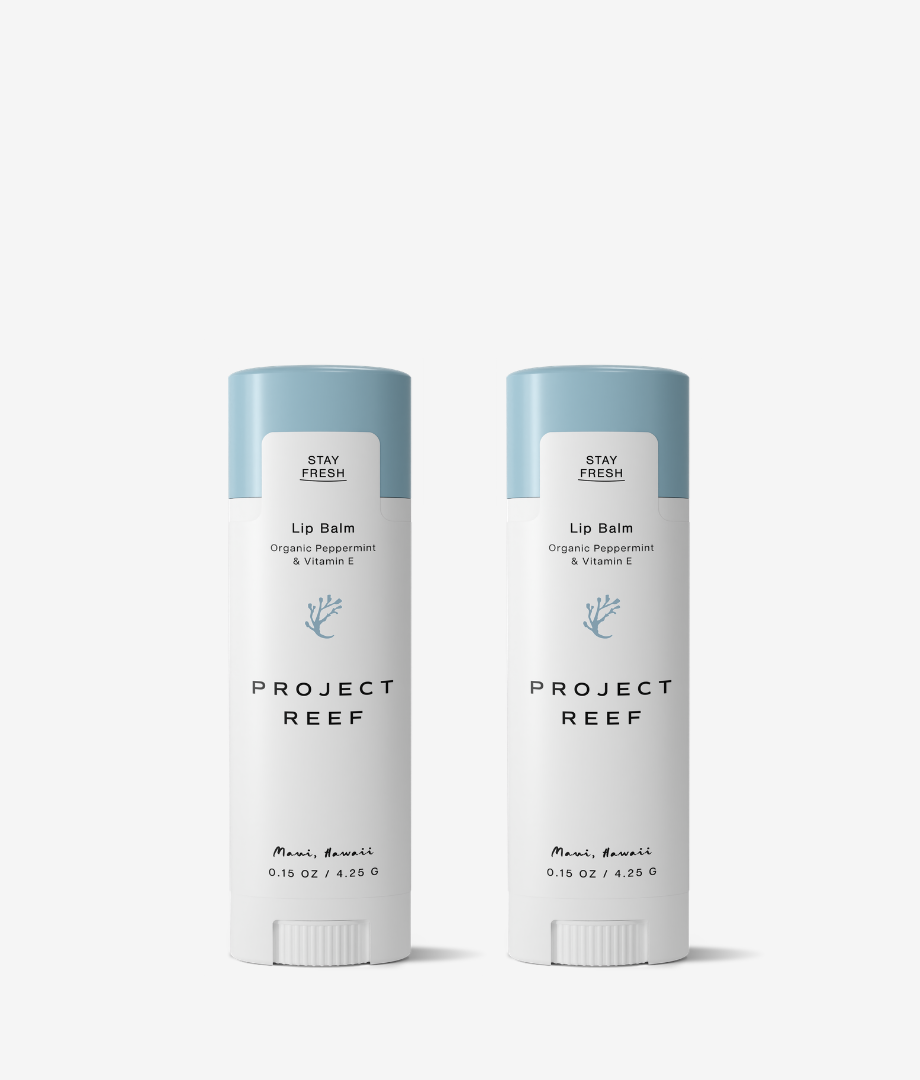Two Project Reef lip balm sticks on a white background