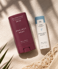 Two Project Reef sun care products on a textured surface 